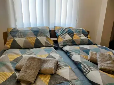 a bed with two pillows on top of it at Studio Bajka in Kanarevo Brdo