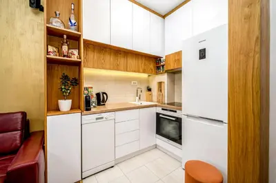 a kitchen with white cabinets and white appliances at Apartment Urban Garden in Belgrade