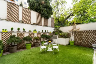 a small garden with a table and chairs on the grass at Apartment Urban Garden in Belgrade