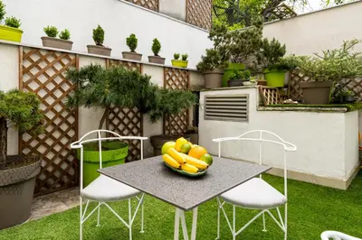 a table and chairs with a bowl of fruit on it at Apartment Urban Garden in Belgrade