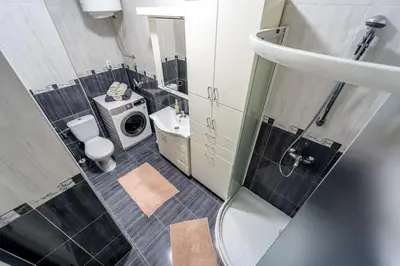 a bathroom with a shower and a toilet and a sink at Apartment Urban Garden in Belgrade