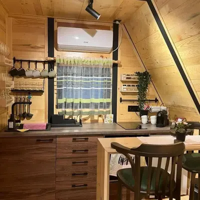 a kitchen with a table in a tiny house at Apartman Durtanoski in Belgrade