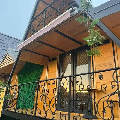 a balcony with an iron railing on a house at Apartman Durtanoski in Belgrade