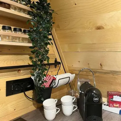 a plant sitting on top of a stove with cups at Apartman Durtanoski in Belgrade