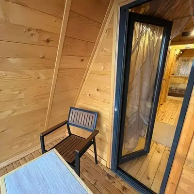 a bench on the porch of a log cabin at Apartman Durtanoski in Belgrade