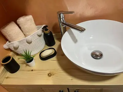 a bathroom counter with a white sink and towels at Apartman Durtanoski in Belgrade