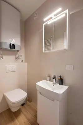 a bathroom with a white sink and a toilet at Apartment Artistique in Belgrade