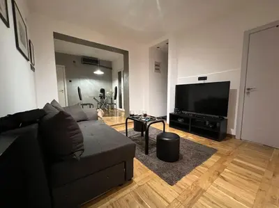 a living room with a couch and a flat screen tv at Lola in Voždovac