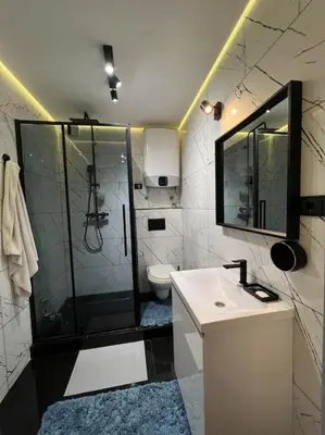 a bathroom with a shower and a sink and a toilet at Lola in Voždovac