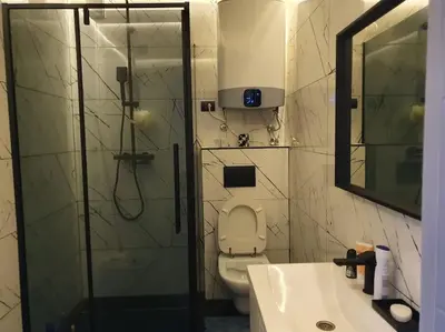 a bathroom with a shower and a toilet and a sink at Lola in Voždovac