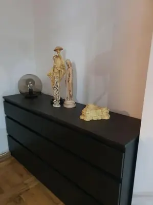 a black dresser with some items on top of it at Lola in Voždovac