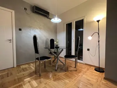 a dining room with a table and two chairs at Lola in Voždovac