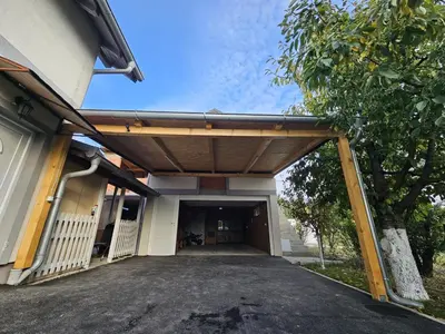 a garage entrance to a building with a wooden garage door at Airport Apartment in Surčin