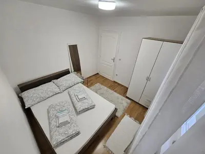 a bedroom with a bed and two pillows on it at Airport Apartment in Surčin