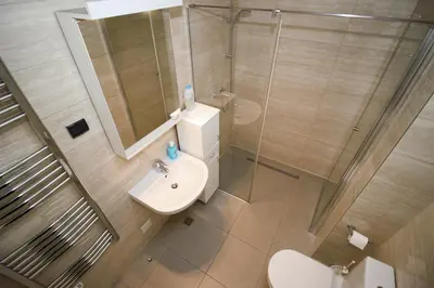 a bathroom with a sink and a shower and a toilet at Apartment A Block Nota Delta City New Belgrade in Novi Beograd