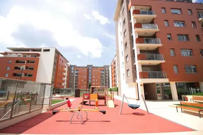 a playground in the middle of a city with buildings at Apartment A Block Nota Delta City New Belgrade in Novi Beograd