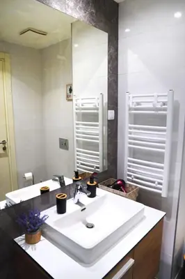 a bathroom with a white sink and a mirror at Verde Comfortable Apartment in Belgrade
