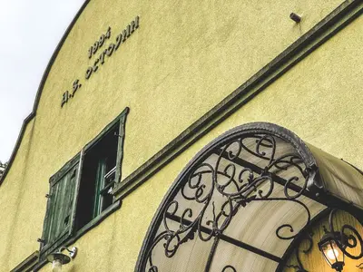 a building with a window and a sign on it at Wood Mood Apartman Tiganjica in Staji°evo