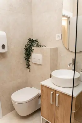 a bathroom with a toilet and a sink and a mirror at SINFONIA LUX in Belgrade