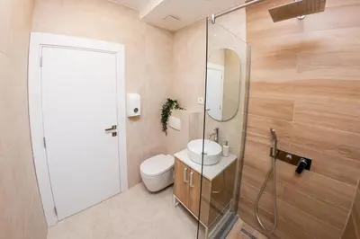 a bathroom with a toilet and a sink and a shower at SINFONIA LUX in Belgrade