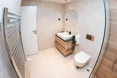 a bathroom with a toilet and a sink and a mirror at SINFONIA LUX in Belgrade