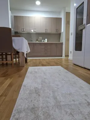a large kitchen with a table and a white refrigerator at RIVIJERA CITY in Belgrade