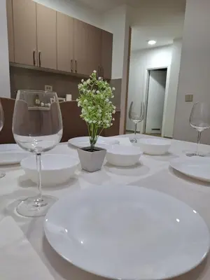 a table with white plates and wine glasses on it at RIVIJERA CITY in Belgrade