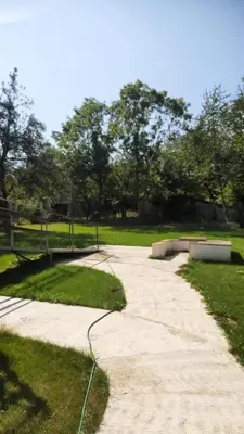 a concrete path in a park with a skateboard at Green Oasis 30 km from downtown Belgrade in Gaglovo