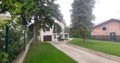 a white house with a yard with a driveway at Green Oasis 30 km from downtown Belgrade in Gaglovo