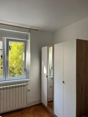 an empty room with a window and a door at MinuteToRiver Apartment in Belgrade