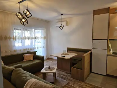 a living room with a couch and a table at Apartman Meggy in Belgrade