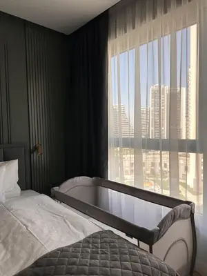 a bedroom with a bed and a bath tub next to a window at DOM Boutique Apartments VERDE in Belgrade