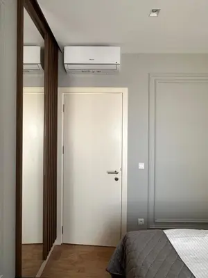 a bedroom with a white door and a bed at DOM Boutique Apartments VERDE in Belgrade