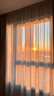 a window with a view of the sunset at DOM Boutique Apartments VERDE in Belgrade