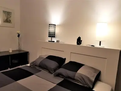 a bedroom with a bed with two pillows on it at Arena West Apartment in Novi Beograd