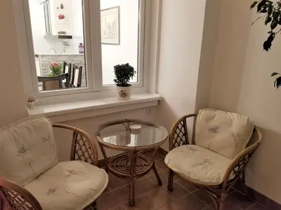 a room with two chairs and a table and a window at Arena West Apartment in Novi Beograd