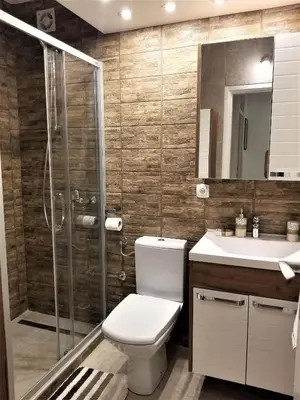 a bathroom with a toilet and a shower and a sink at Arena West Apartment in Novi Beograd