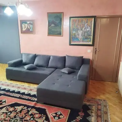 a living room with a blue couch in a room at Dream 2 in Belgrade