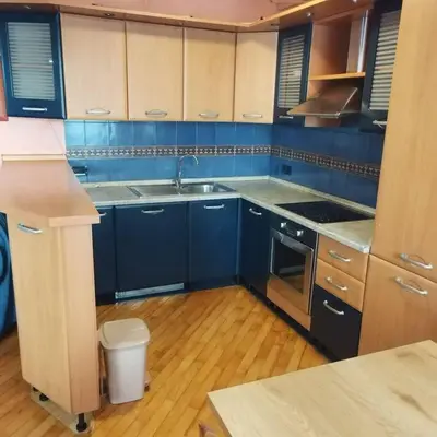 a blue kitchen with a sink and a stove at Dream 2 in Belgrade