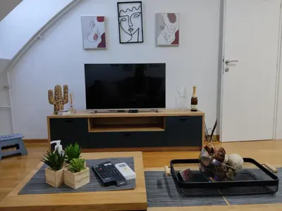 a living room with a tv and a table at City011 in Belgrade