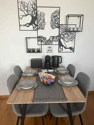 a wooden table with chairs and a bowl of food on it at City011 in Belgrade