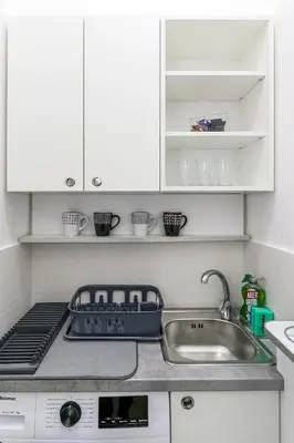 a kitchen counter with a sink and a stove at City011 in Belgrade
