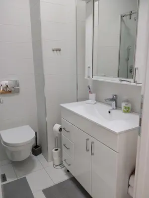 a white bathroom with a toilet and a sink at City011 in Belgrade