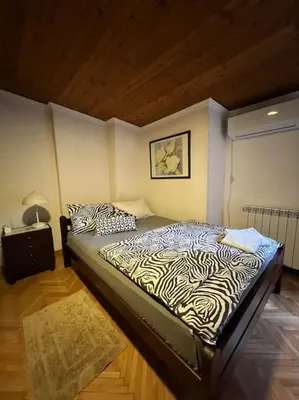 a bedroom with a zebra print bed in a room at OASIS IN CENTER OF VRACAR in Vračar (historical)