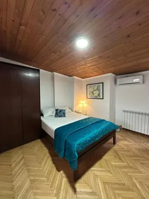 a bedroom with a bed and a wooden ceiling at OASIS IN CENTER OF VRACAR in Vračar (historical)