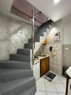 a staircase leading up to a kitchen in a house at OASIS IN CENTER OF VRACAR in Vračar (historical)