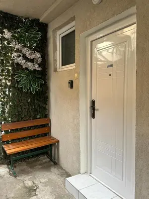 a door to a house with a bench next to it at OASIS IN CENTER OF VRACAR in Vračar (historical)