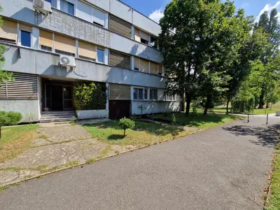 an empty street in front of a building at Royal apartment Sava river Blok 70 in Ada Ciganlija