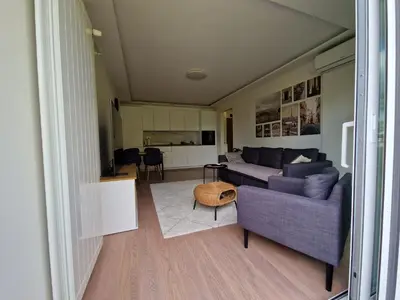 a living room with a couch and a table at Royal apartment Sava river Blok 70 in Ada Ciganlija
