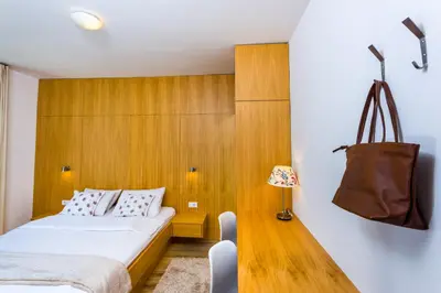 a bedroom with two beds and a purse on the wall at Arena Penthouse Apartments in Belgrade